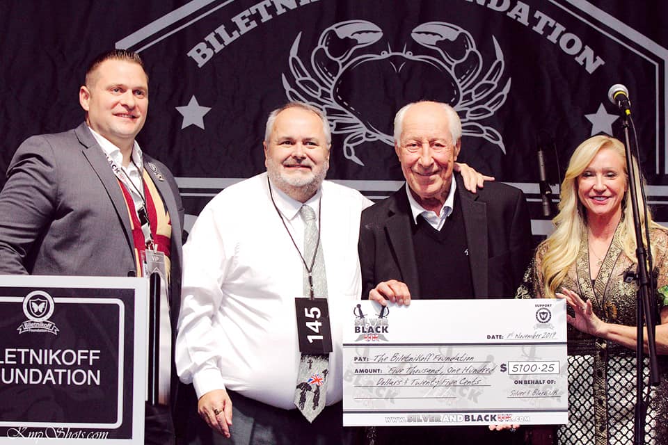 Co-founder Oli DeRuyter and one of it's lead officers Keith Smith present a cheque for $5000.25 to the Biletnikoff Foundation at the 2019 Crab Fest
